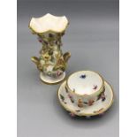 A Meissen miniature tea bowl and saucer and vase with floral design