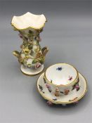 A Meissen miniature tea bowl and saucer and vase with floral design