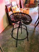 A Black tractor seat stool