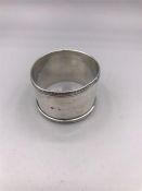 A silver napkin ring, hallmarked Birmingham, makers mark P & S.