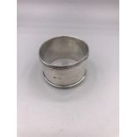 A silver napkin ring, hallmarked Birmingham, makers mark P & S.