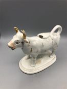 A Staffordshire cow creamer (Chip to lid)