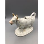 A Staffordshire cow creamer (Chip to lid)