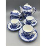 A Ringways Blue and white teapot, three cups and saucers and a sugar bowl