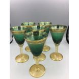 A set of six green wine glasses