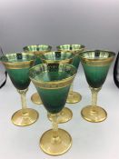 A set of six green wine glasses