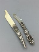 Two silver handled letter openers, one ivory, hallmarked 1846/7 and another mother of pearl maker C&