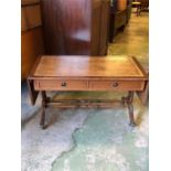 A leather topped drop leaf sofa table