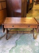 A leather topped drop leaf sofa table