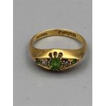 An 18ct gold ring with emeralds and diamonds