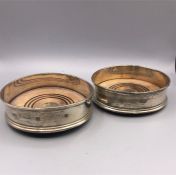 A pair of hallmarked silver wine coasters