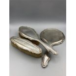 A hallmarked silver backed ladies dressing table set, comprising a hand mirror and two brushes.