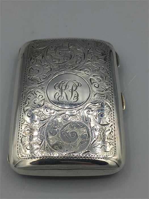 A silver cigarette case, heavily engraved, hallmarked Birmingham 1909/10