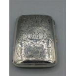 A silver cigarette case, heavily engraved, hallmarked Birmingham 1909/10