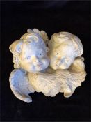 A stone garden cherub plaque