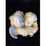 A stone garden cherub plaque