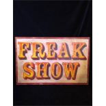 A large wooden 'Freak Show' fairground style sign