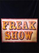 A large wooden 'Freak Show' fairground style sign