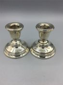 A pair of silver candlesticks, hallmarked Birmingham.