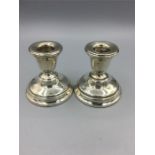 A pair of silver candlesticks, hallmarked Birmingham.