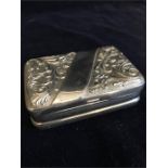 A white metal pill box