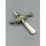 A mother of pear handled babies rattle in silver