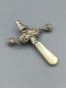 A mother of pear handled babies rattle in silver