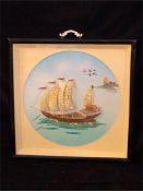 A Chinese framed picture of a boat.
