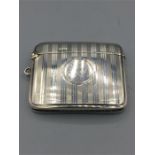 A silver, match case 13/4" x 21/4", regency stripe engraving, hallmarked Birmingham 1919/20