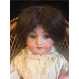 An Arman Marseille bisque doll, socket head Germany SA/039 DEP 6 with feather boa and seed pearl