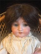 An Arman Marseille bisque doll, socket head Germany SA/039 DEP 6 with feather boa and seed pearl