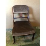 A nursing chair on castors with inlaid detail