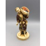 A Satsuma figure of a man carrying a basket of fish