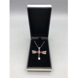 A silver ruby and opal dragon fly pendant necklace on silver chain