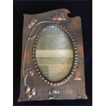 An Art Nouveau copper picture frame