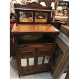 A Chiffonier with mirrored panels and back