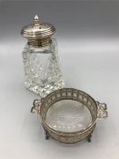 A silver topped sugar sifter and a glass dish in a silver mount.