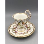 A Dresden cup and saucer with rare eagle handle
