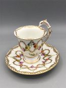 A Dresden cup and saucer with rare eagle handle