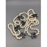 A Long string of freshwater black and white pearls with chanel style spacers