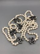 A Long string of freshwater black and white pearls with chanel style spacers