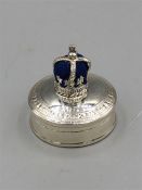 A silver pill box with pincushion to the lid in the form of a crown