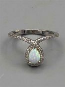 A silver CZ and opal dress ring