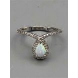 A silver CZ and opal dress ring