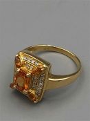 A 14ct yellow gold citrine and diamond cluster ring