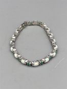 A silver CZ opal and emerald bracelet