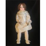 An Armand Marseille bisque doll with socket head, chestnut hair 65cm tall Germany 390 A.9.M