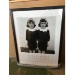 A framed picture of twins by Diane Arbus