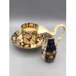 A Crown Derby tea cup, saucer and jug (AF)