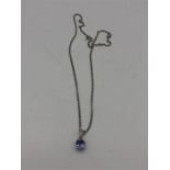 An 18ct white gold necklace with a sapphire pendant